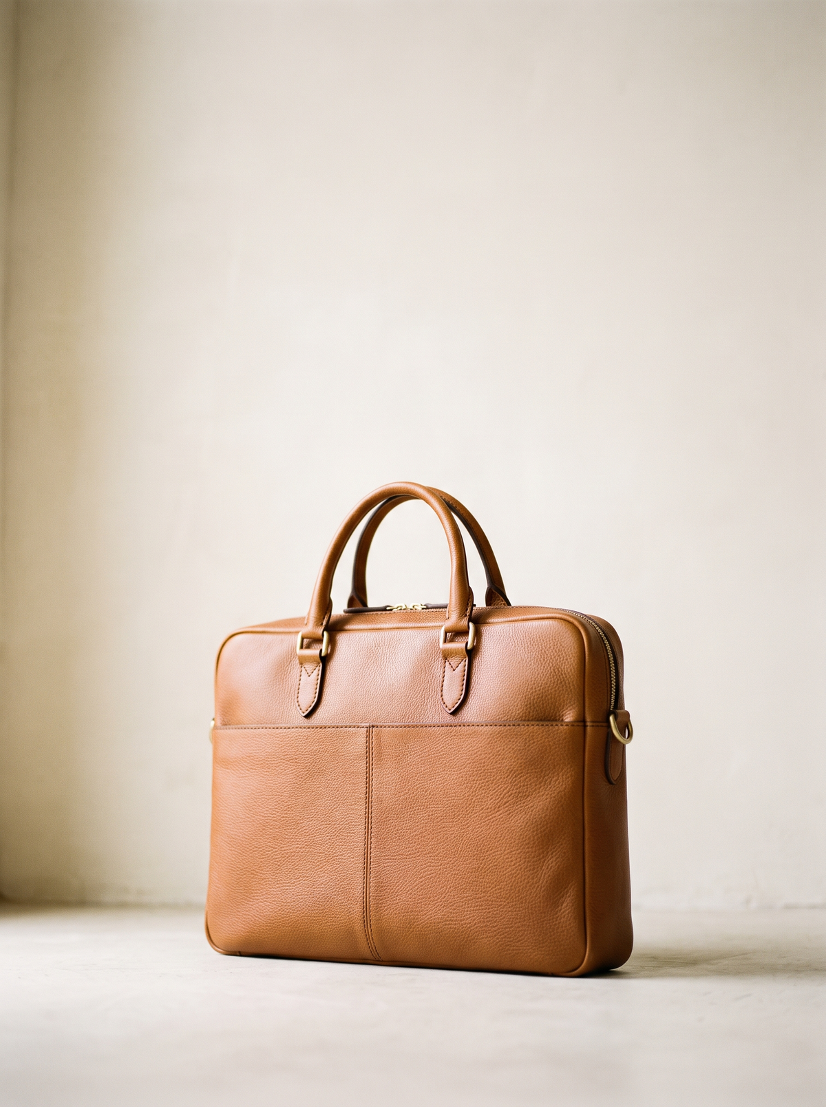 A tan leather laptop bag