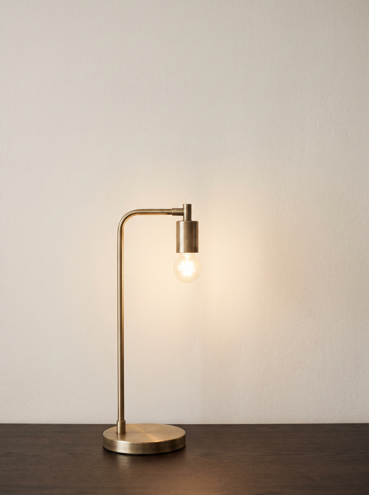 A slim brass desk lamp