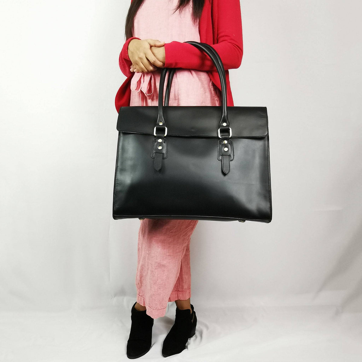 Black leather laptop bag with a full flap closure