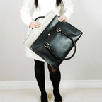 Black leather laptop bag with a full flap closure