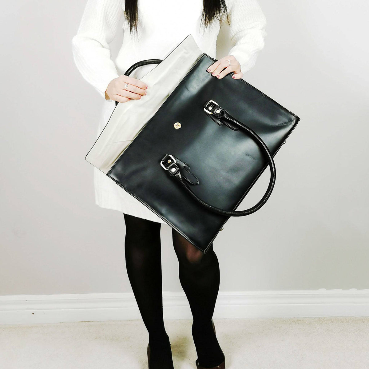 Black leather laptop bag with a full flap closure