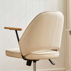 Upholstered rolling office chair on castors