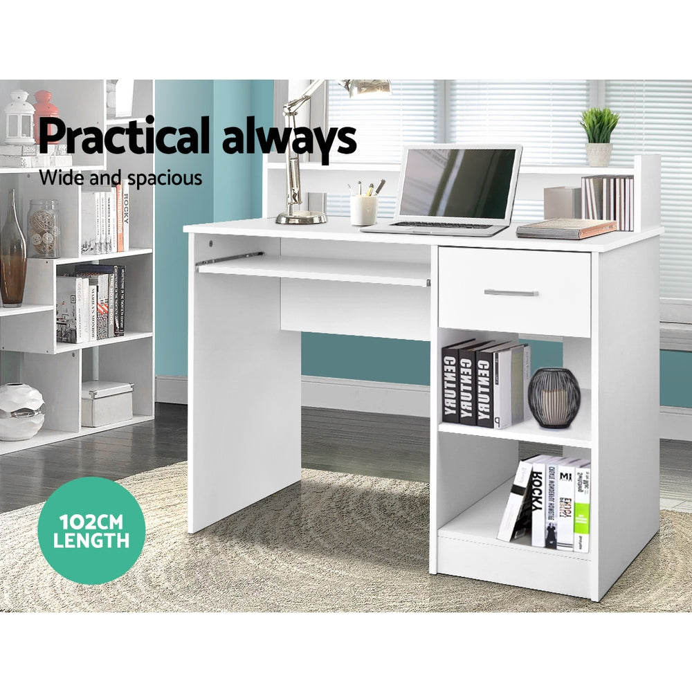 White desk with a slide out keyboard tray and open shelving