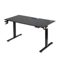 Black electric standing desk at standing height