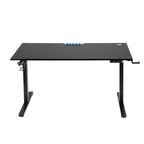 Black electric standing desk at standing height