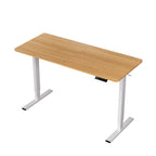 Height adjustable standing desk with an oak top and white frame