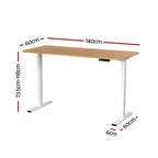 Height adjustable standing desk with an oak top and white frame