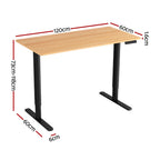 Electric sit stand desk with a natural wood top raised to standing height