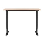 Electric sit stand desk with a natural wood top raised to standing height