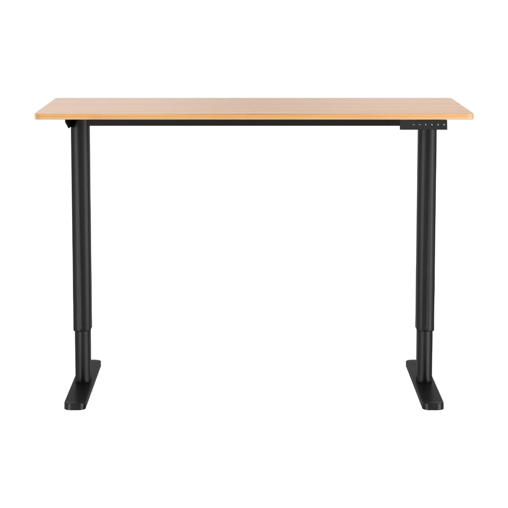Electric sit stand desk with a natural wood top raised to standing height