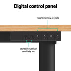 Electric sit stand desk with a natural wood top raised to standing height