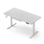 White electric standing desk with a built in stationery drawer