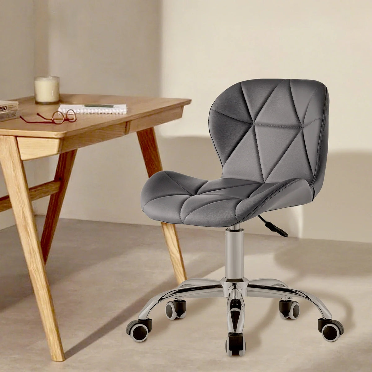 Grey swivel office chair on chrome legs with castors