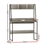 Grey steel workstation desk with a partitioned shelf above the work surface
