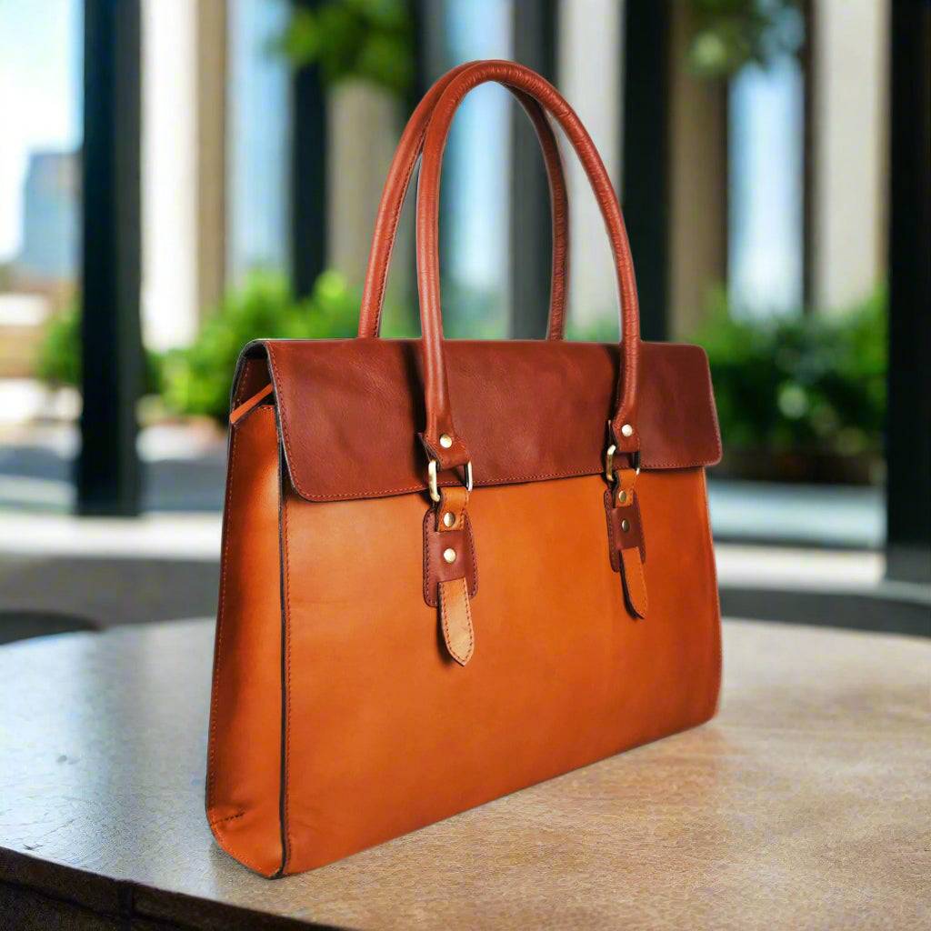 Tan leather laptop bag with a full flap closure