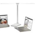 White double arm banker lamp folded over a desk