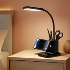 Black desk lamp with an integrated wireless charging pad and pen holder