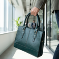 The Signature Leather Laptop Bag, Bottle Green 15 inch — carried in an office corridor