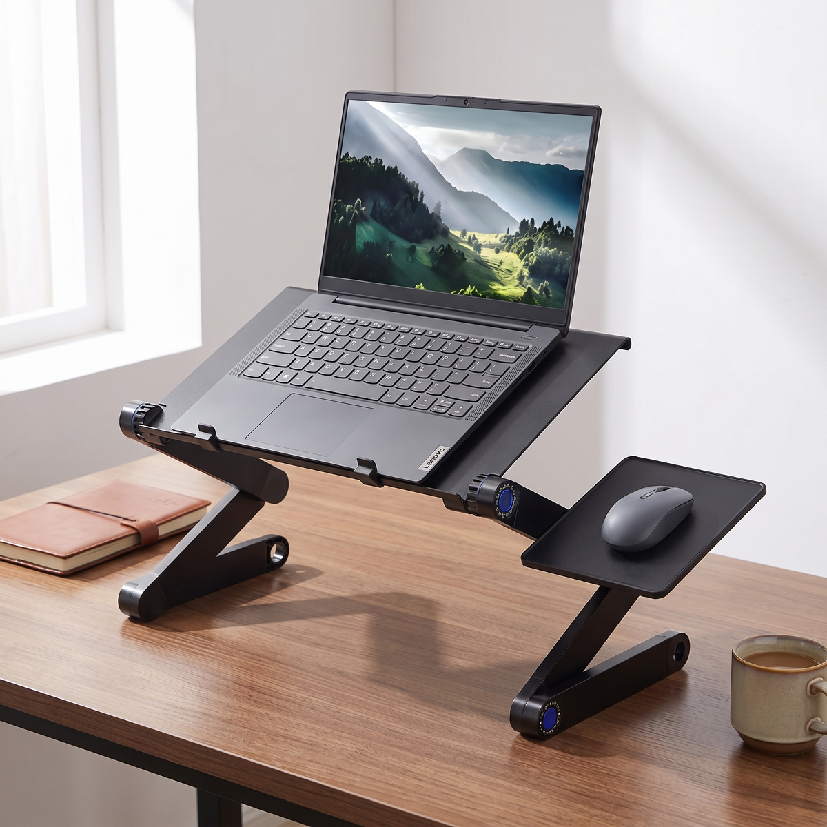 Foldable aluminium laptop stand with mouse board in use on a desk