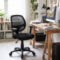 Black mesh mid-back office chair beside a desk in a home office