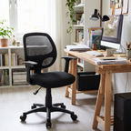 Black mesh mid-back office chair beside a desk in a home office