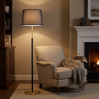 Traditional floor lamp with linen shade beside a reading chair in the evening