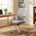 White-frame ergonomic mesh office chair at a desk in a bright home office