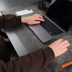 Grey leather desk pad laid across a desk