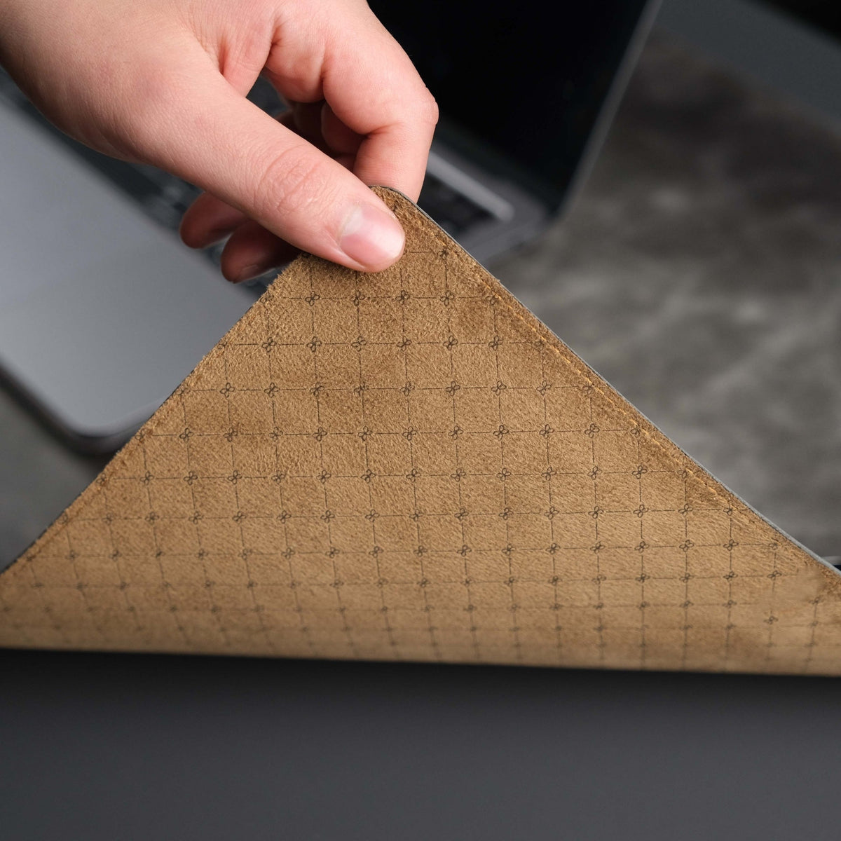 Grey leather desk pad laid across a desk