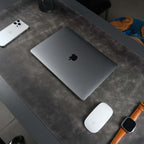 Grey leather desk pad laid across a desk