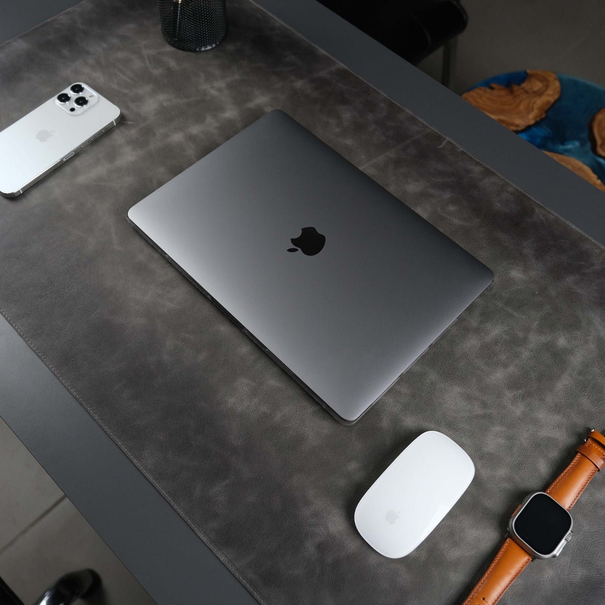 Grey leather desk pad laid across a desk