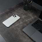 Grey leather desk pad laid across a desk