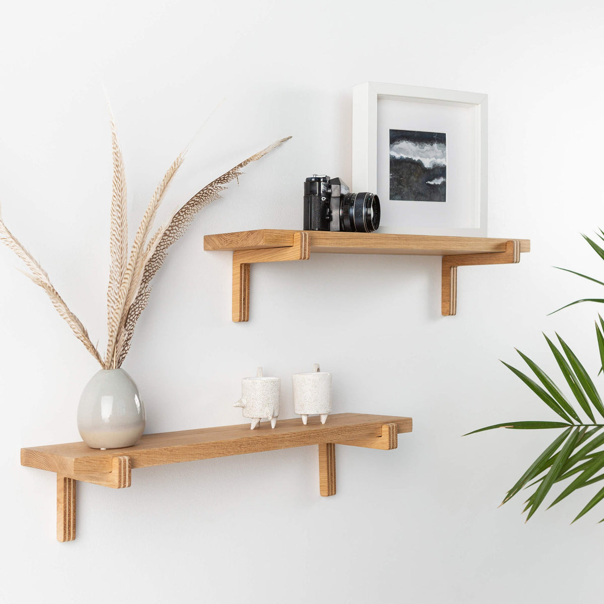 Pair of oak floating wall shelves with holders