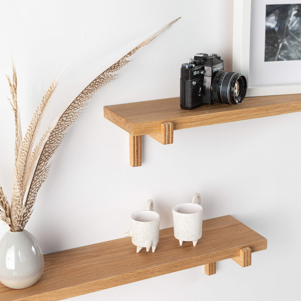 Pair of oak floating wall shelves with holders