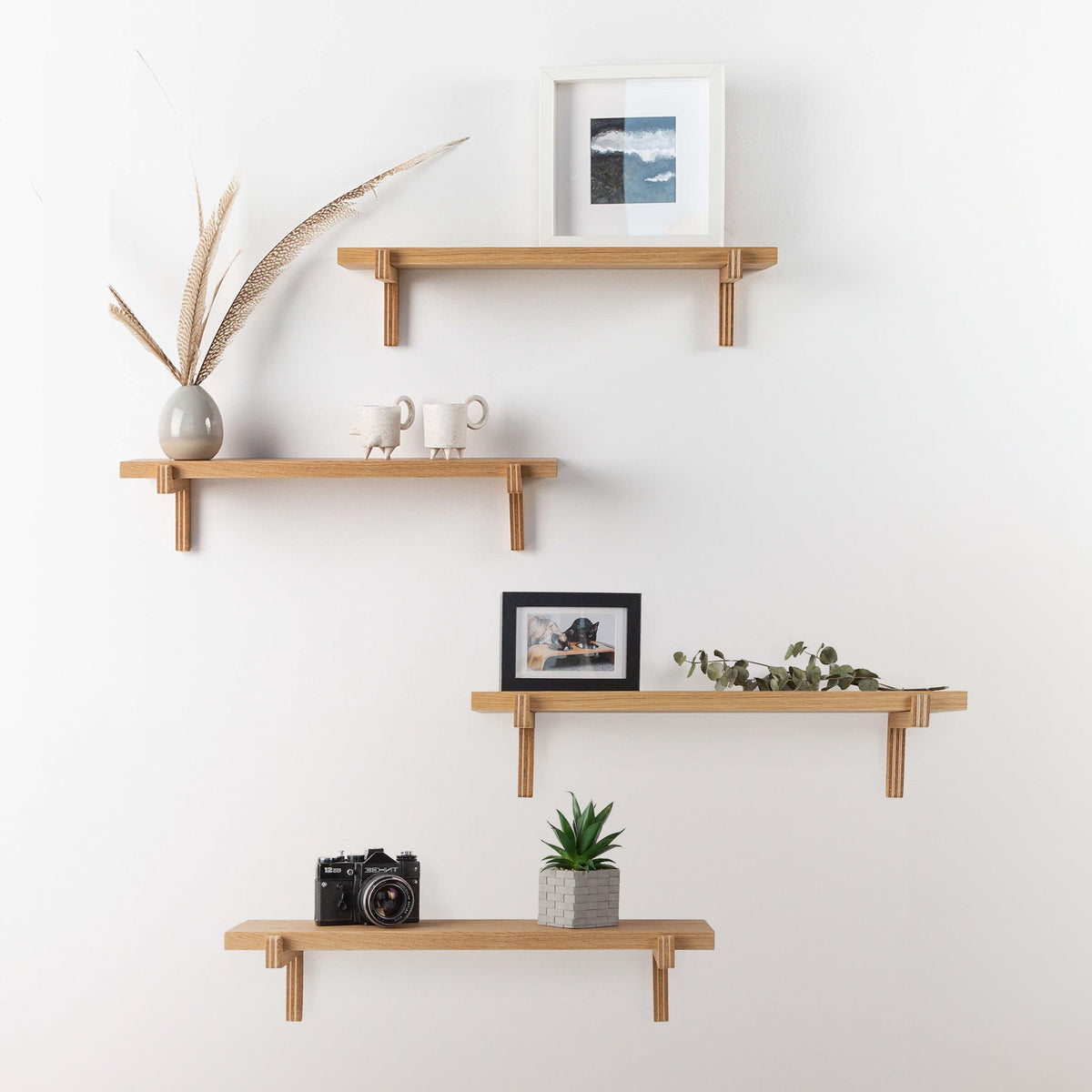 Pair of oak floating wall shelves with holders